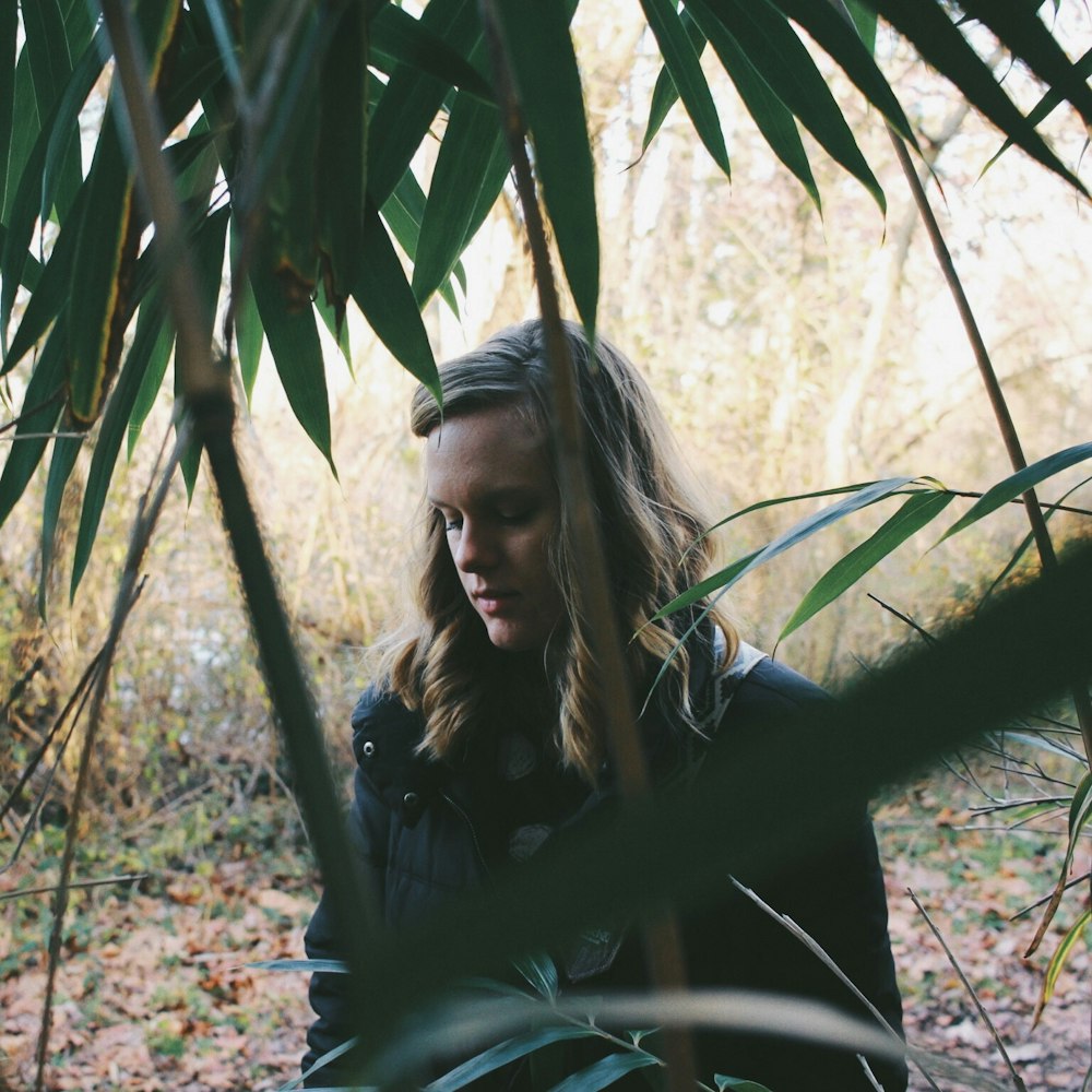 woman standing in forest