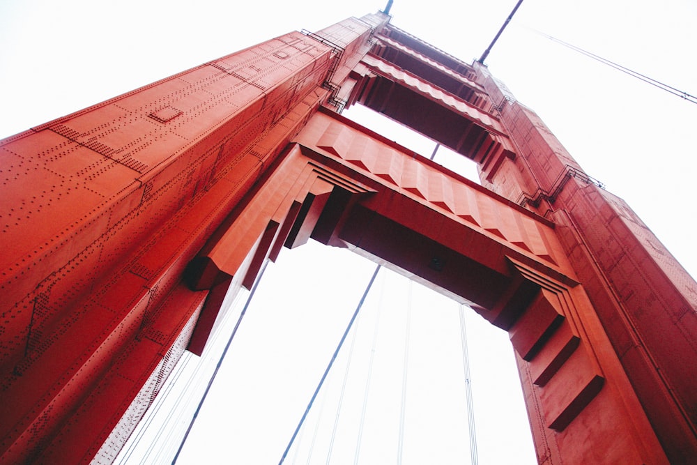 low angle photo of red suspension bridge