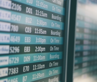 Airport departures timetable showing Delta and Alaska Airlines flights on time and boarding