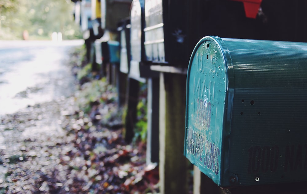 tilt shift photography of green mailbox