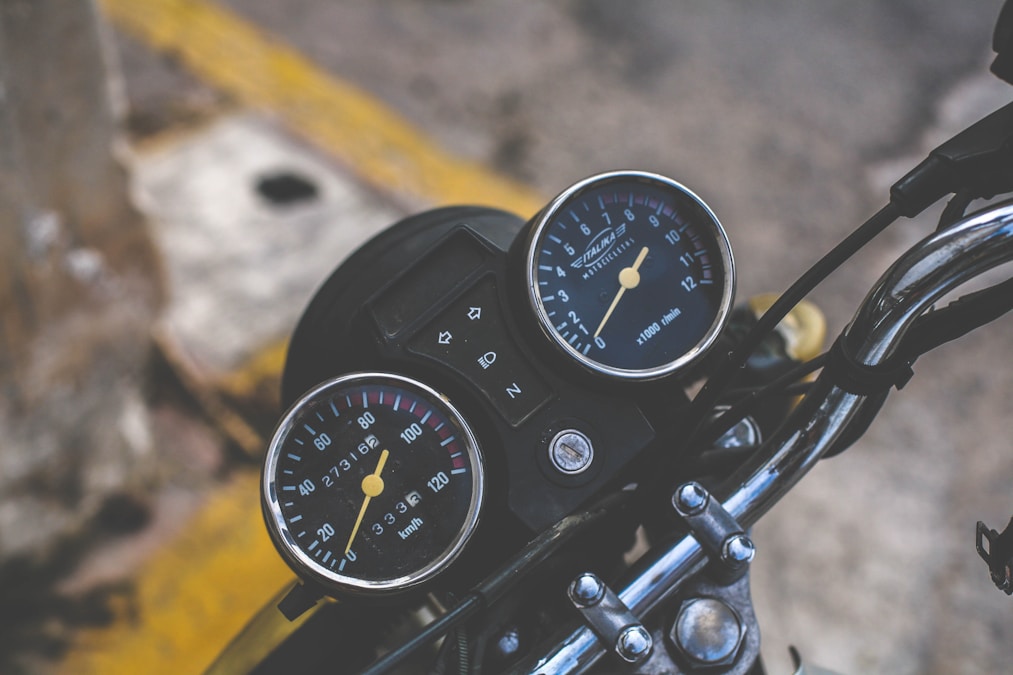 Motorcycle cockpit gauges and handlebars — odometer and control inspection context