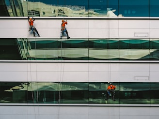 man cleaning white building