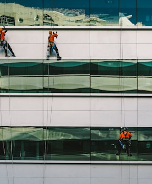 man cleaning white building