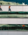 man cleaning white building