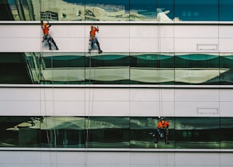 man cleaning white building