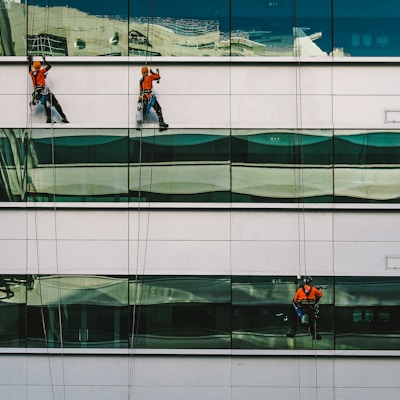 man cleaning white building