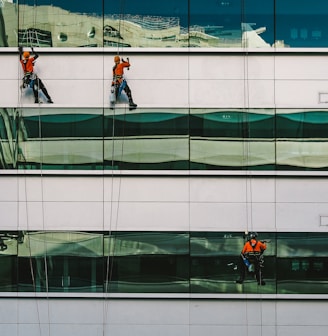 man cleaning white building