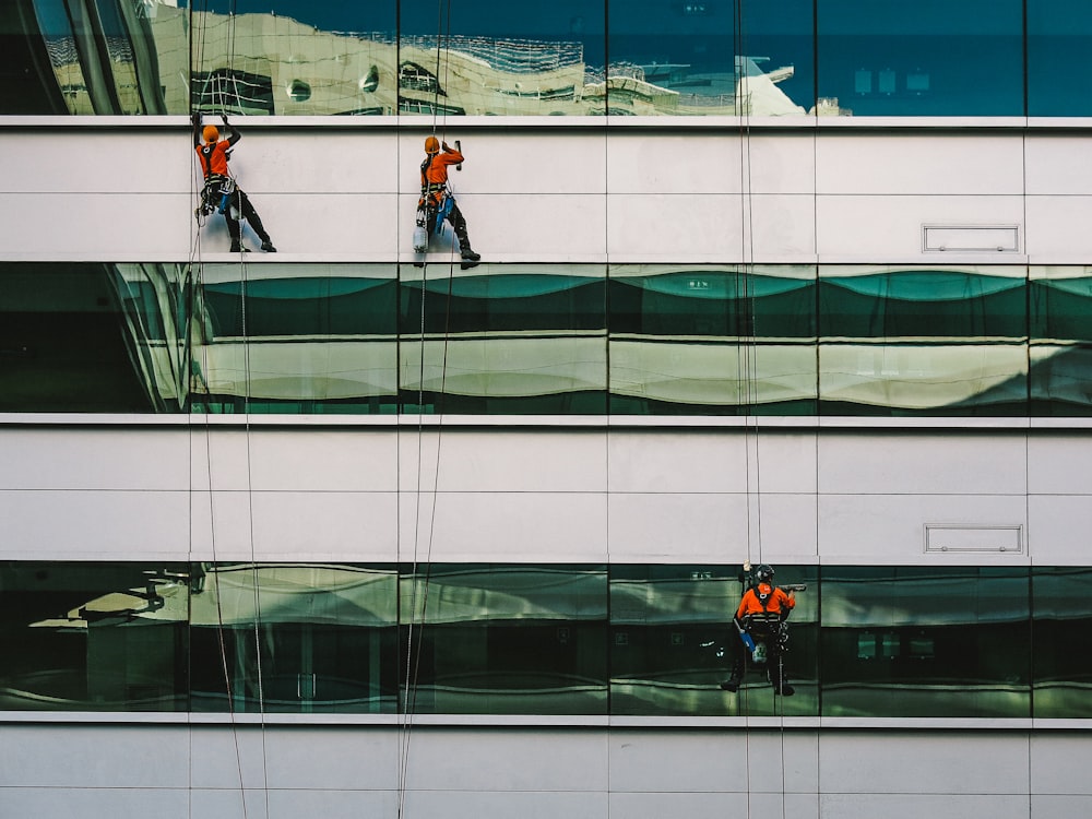 man cleaning white building