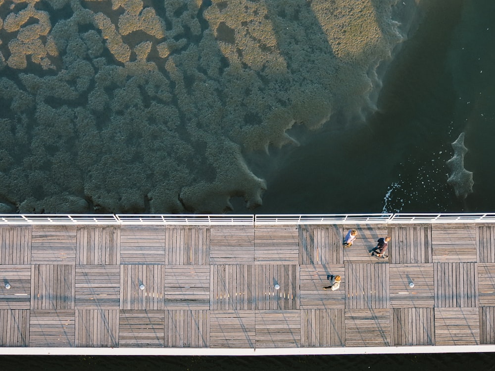 drone view of people walking on bridge
