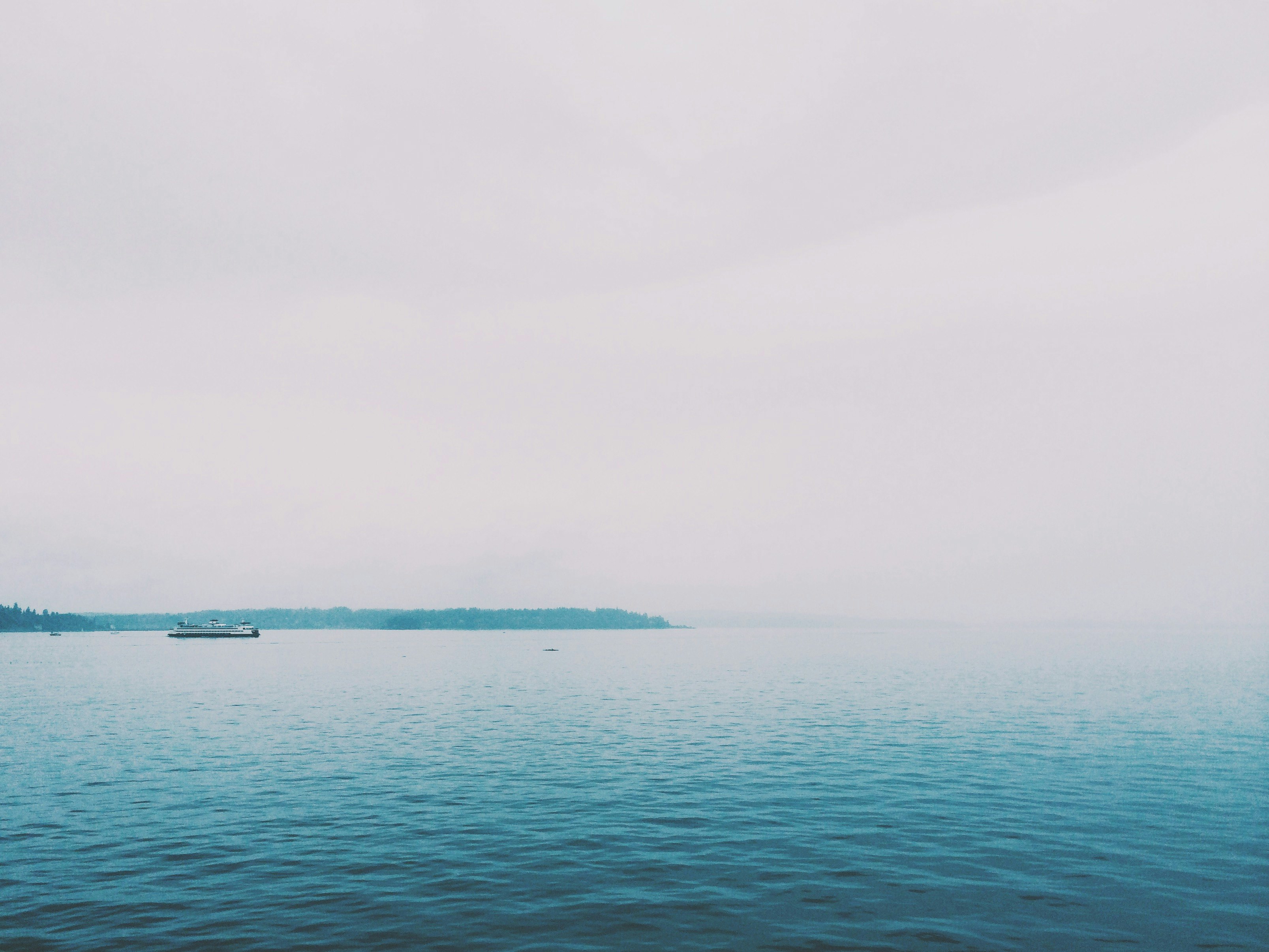 blue sea under gray sky