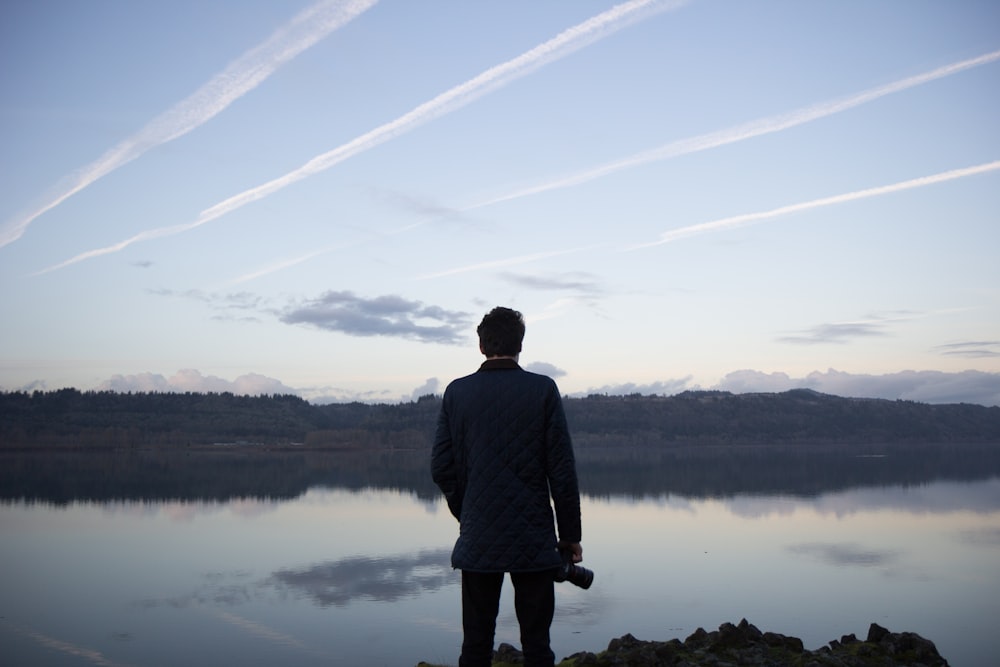 man in black top under cloudy sky