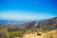 A hiker enjoying panoramic views from a rocky viewpoint in Potrero de los Funes.