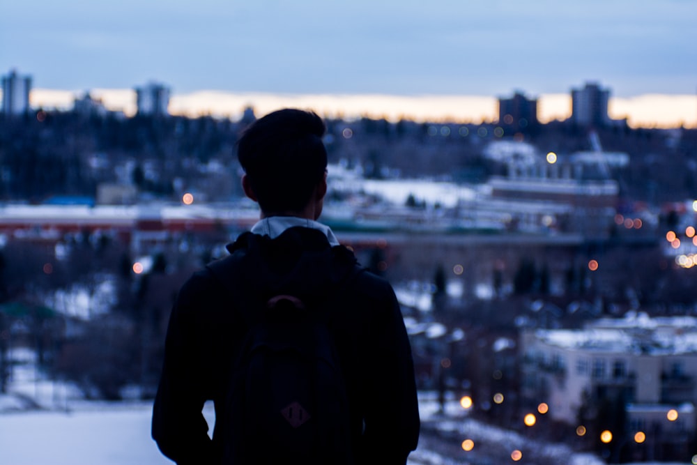 a person looking out over a city at night