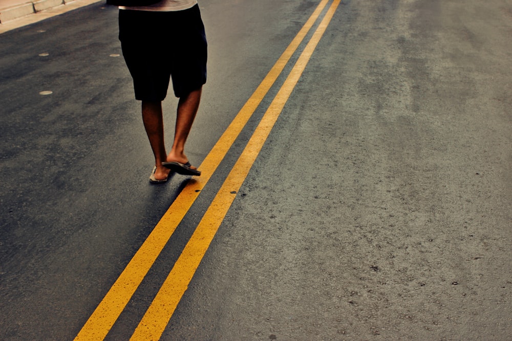 person walking in the middle of the street