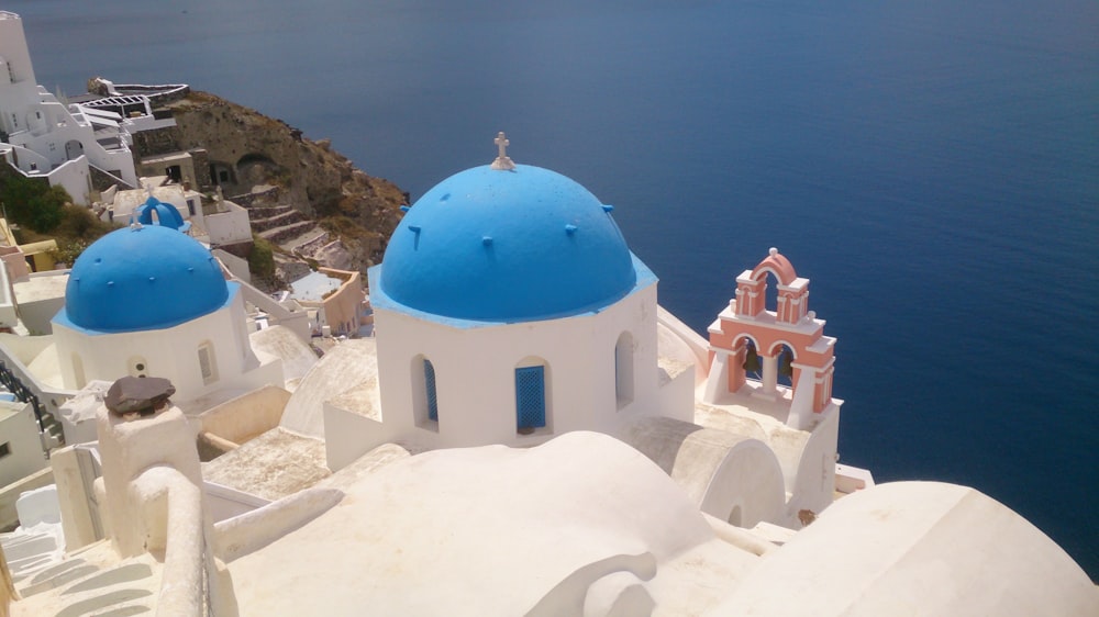 white and blue concrete building near seawater