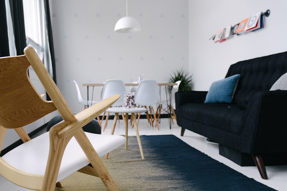 White chairs and a black sofa in a rest area in an office