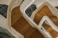 Close-up of a geometric staircase with sharp angles and a white backdrop.