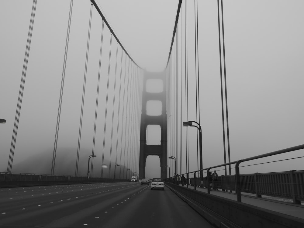 cars on bridge grayscale photo