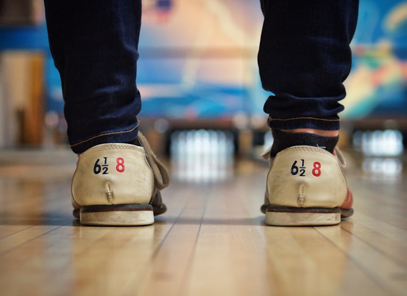 Senior bowler preparing to roll a bowling ball down the lane