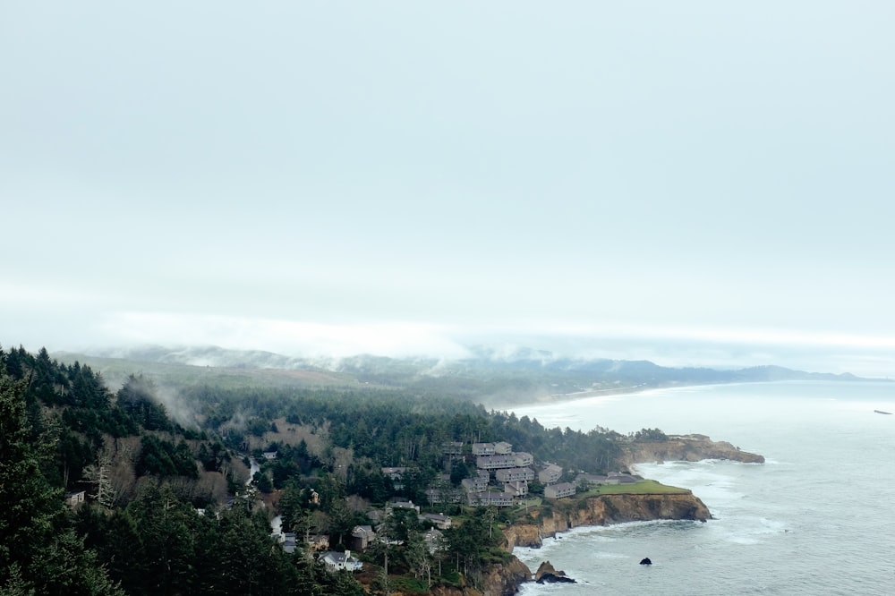 aerial photography buildings on cliff near body of water