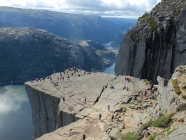 group of people on mountain cliff