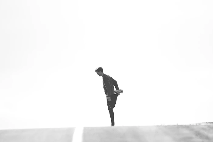 Athlete testing movement in a black performance jacket