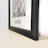 A luxury acrylic frame displayed on a sleek black surface with subtle gold accents.