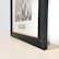 A luxury acrylic frame displayed on a sleek black surface with subtle gold accents.