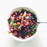 A vibrant seafood salad with colorful vegetables and a light dressing served in a bowl.