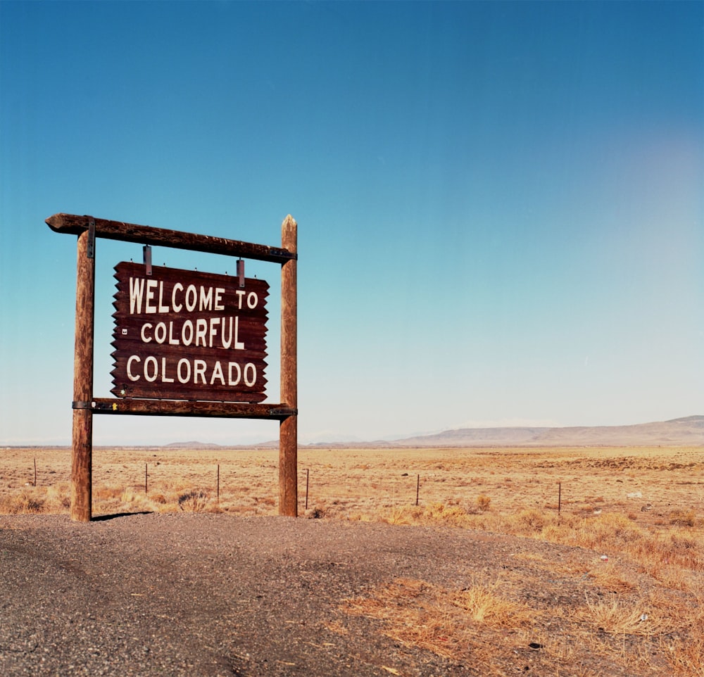 Welcome signage on road during daytime