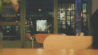 Cozy interior view of a cookie shop with warm lighting and wooden furniture.