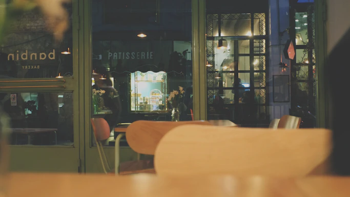 A cozy bakery corner with fresh croissants and a moonlit window view.