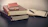 selective focus photography of three books beside opened notebook