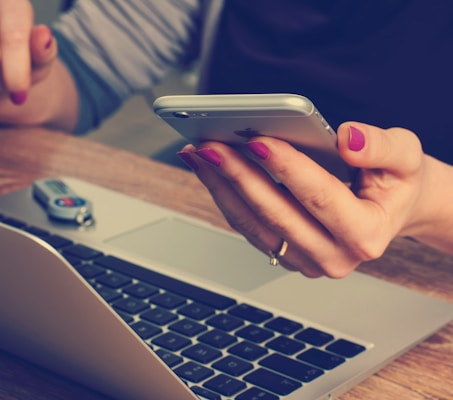 woman holding silver iPhone 6