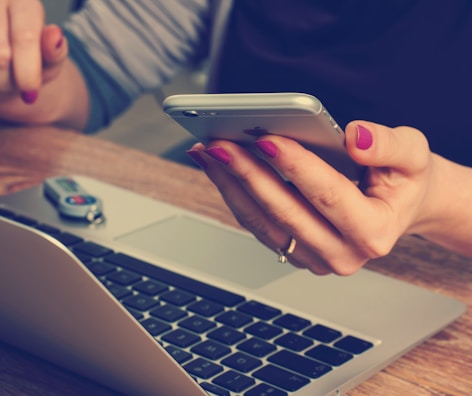 woman holding silver iPhone 6