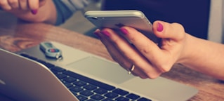 woman holding silver iPhone 6