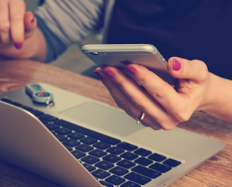 woman holding silver iPhone 6