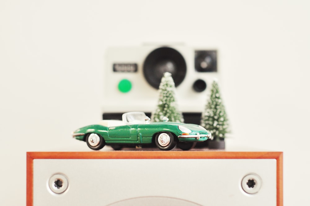selective focus photography of green coupe die-cast model