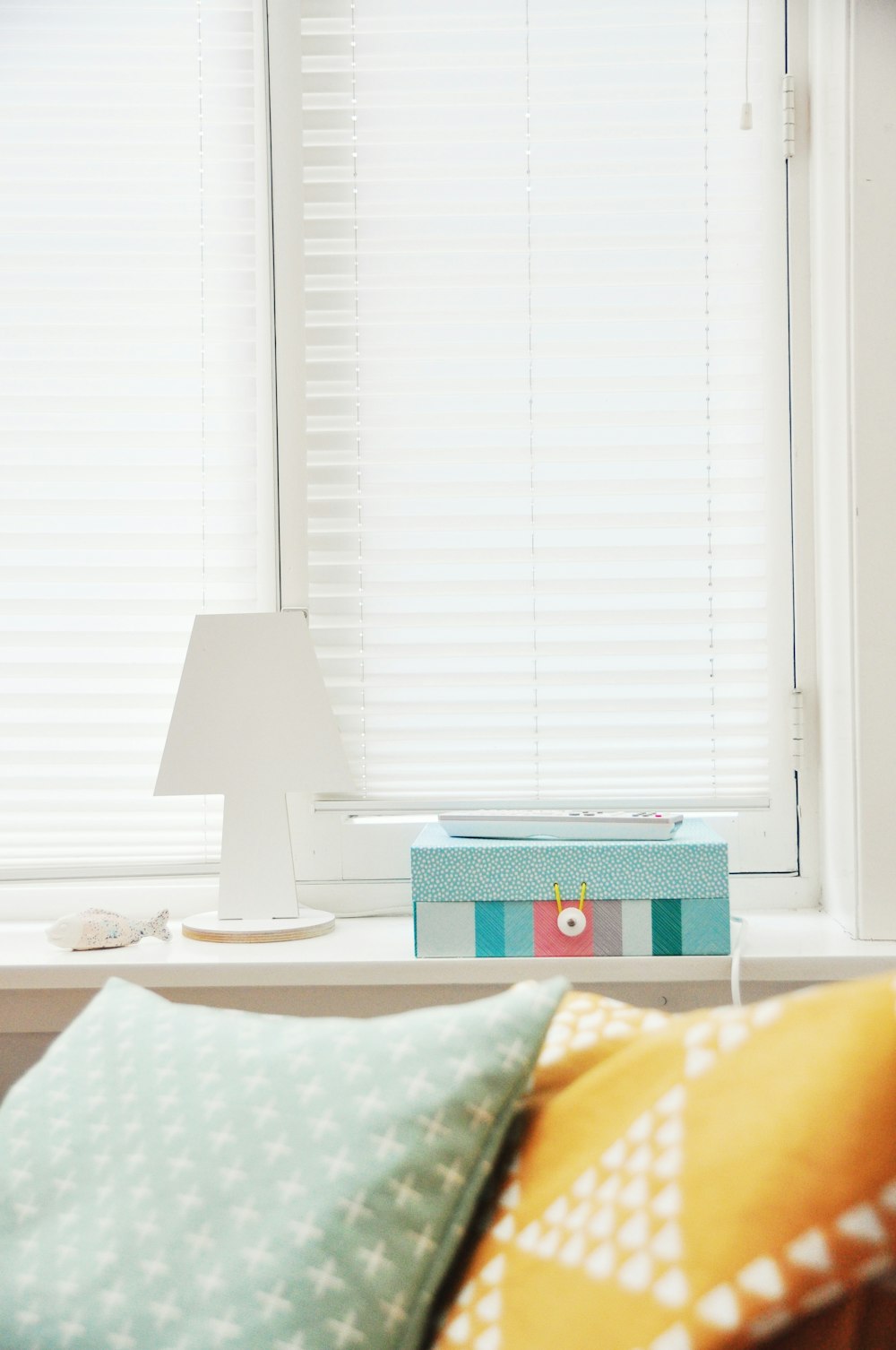 white wooden lampshade near window blinds