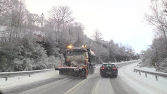 A snowplow clearing a snowy road.