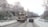 A snow-covered driveway being cleared by a snow removal vehicle.