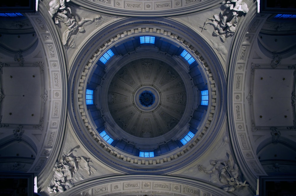 the ceiling of a building with a circular window