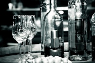 Elegant wine bottles and glasses arranged on a rustic wooden table.