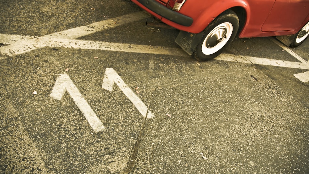 red car on black asphalt road