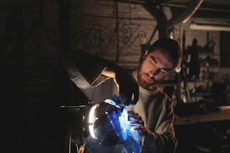 Technician assisting a client with calibration equipment in a bright workshop
