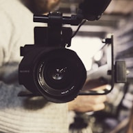 closeup photo of person carrying professional video recorder