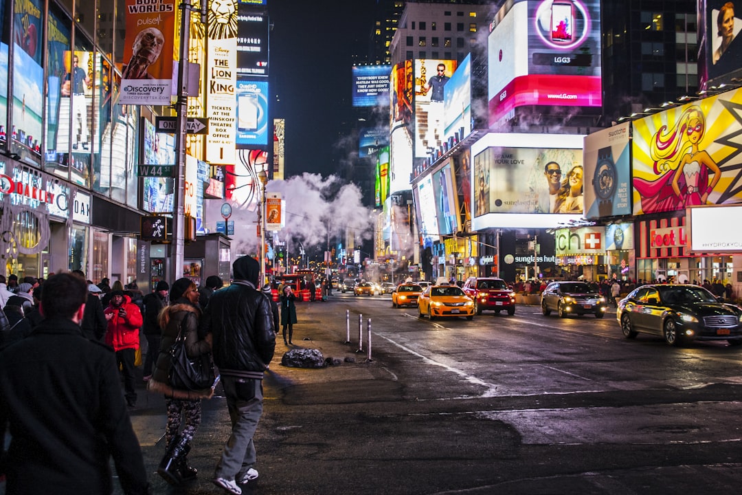 people walking beside buildings, Times Square never shined so bright