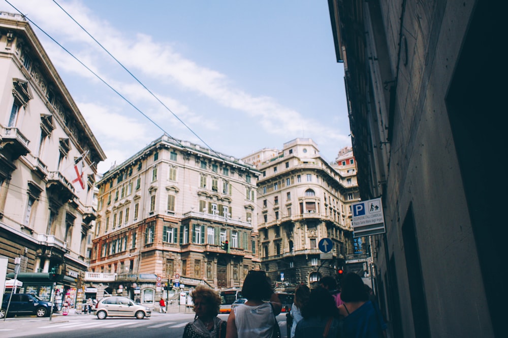 people at the street surrounded with buildings during daytime