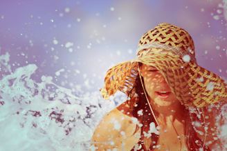 A wide-brimmed sun hat casting a shadow over a sunny beach scene.