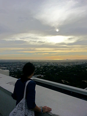 A quiet moment of reflection with Rachit looking over a cityscape at sunset.